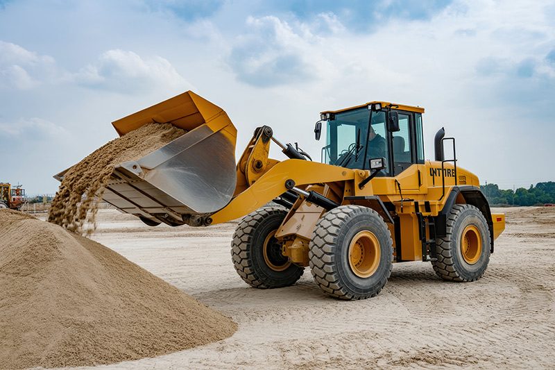 Wheel loader machine unloading sand at eathmoving works in const รถตักดิน